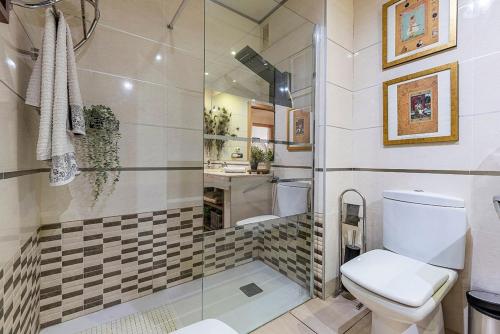a bathroom with a toilet and a shower at Cambrils seaside luxury solarium in Montroig