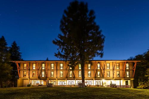 a large building with a tree in front of it at HI Geres - Pousada de Juventude do Gerês in Geres