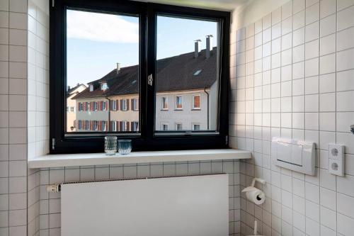 a bathroom with a window with a view of a building at 1 Zimmer-appartment Nr 21 in Wangen im Allgäu