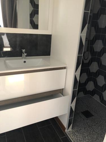 a bathroom with a sink and a shower at Appartement T 2 in La Bourboule