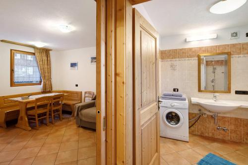 a bathroom with a sink and a washing machine at La Coccinella Livigno in Livigno