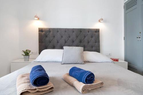 a bedroom with a bed with blue towels on it at Puerto Chico E in Playa Blanca