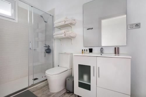 a bathroom with a toilet and a sink and a shower at La Corte A2 in Antigua