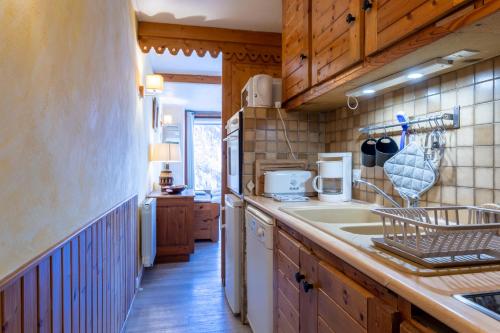 a kitchen with a sink and a counter at L'Alpazen Jouve Studio Terrasse in Saint-Véran