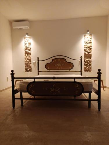 a bed in a room with two lights on the wall at Via Roma 50 in Bacu Abis