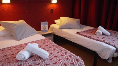 a hotel room with two beds with towels on them at VVF "Piau-Engaly" Aragnouet in Aragnouet