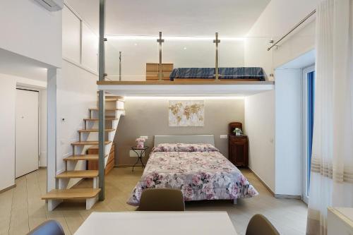 a bedroom with a bed and a staircase in a room at Casa Imperati in Agerola