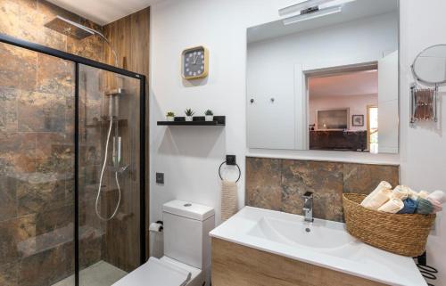 a bathroom with a sink and a toilet and a mirror at Luxury 3 Beds Villa Inside Resort in Estepona