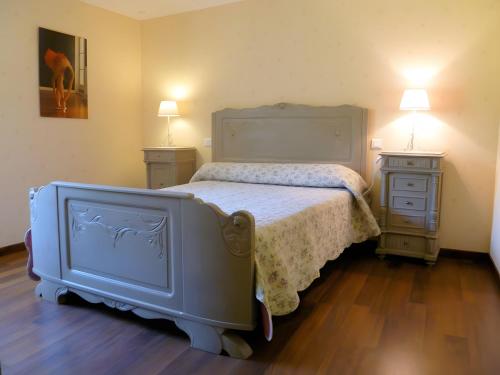 a bedroom with a bed and two night stands at Gite La Lavande in Peyreleau