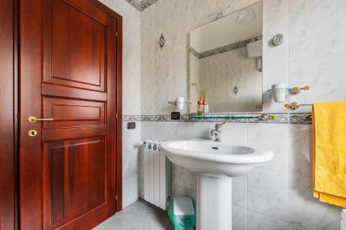 a bathroom with a sink and a mirror at Red House Capoterra in Capoterra