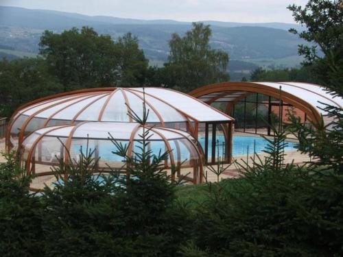 two domes over a swimming pool with a pool at 18 Chalet Myosotis in Blavignac