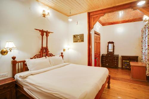 a bedroom with a large bed in a room at Danish Villa Heritage Property in Shimla