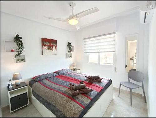 a bedroom with a large bed and a chair at R-15 Large Holiday House in Torrevieja
