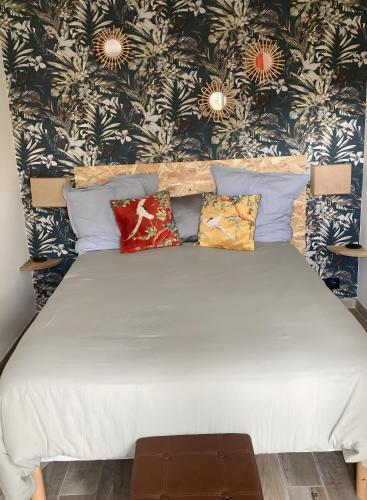 a bedroom with a bed with pillows on it at Chambre D'hôtes - Chambre in Jeufosse