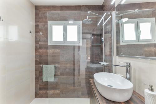 a bathroom with a sink and a glass shower at Teror Hills in Teror