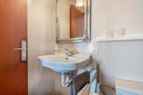 a white bathroom with a sink and a mirror at Bennassar 3 in Felanitx
