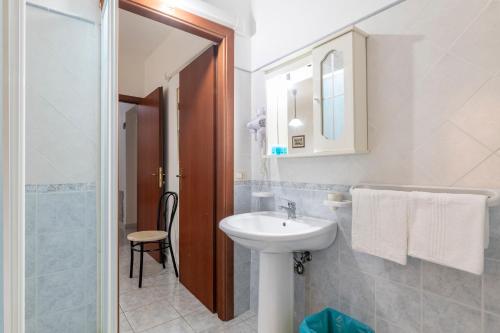 a white bathroom with a sink and a shower at Hotel Da Concetta a Jerzu in Jerzu