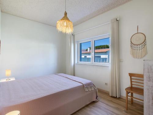 a bedroom with a bed and a window at Villa 32 - Villa With Garden in Esposende