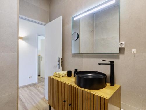 a bathroom with a sink on a wooden counter at Villa 32 - Villa With Garden in Esposende