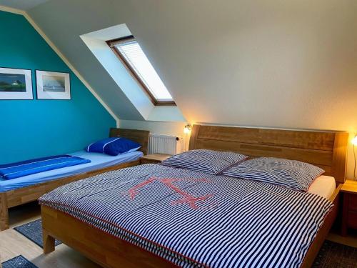 a bedroom with a bed with a red cross on it at Haus Peeneblick in Freest
