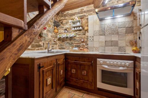 a kitchen with a sink and a stove at Casa Rural Cornatel in Villavieja