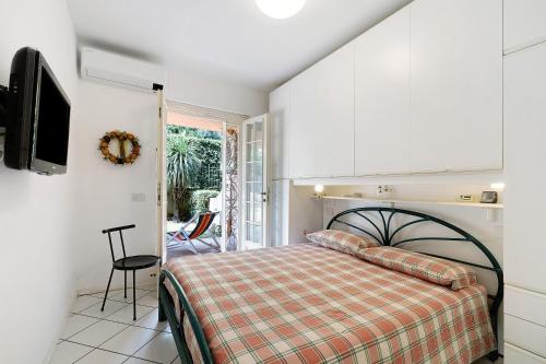 a bedroom with a bed and a tv at Casa Ghibli in Loano