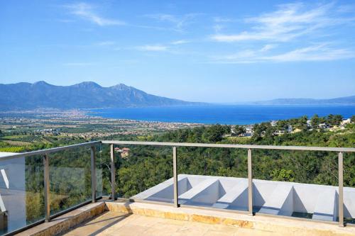 a balcony with a view of the water and mountains at Exclusive Villas in Kuşadası