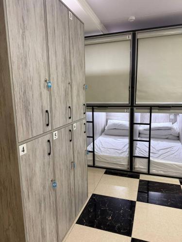 a room with two bunk beds in a room at Palm Hostel in Tashkent