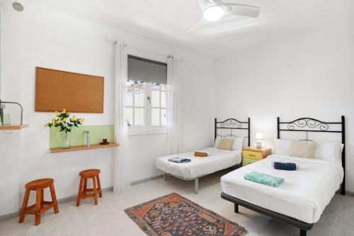 a bedroom with two beds and a couch and a table at Eveas - Villa with Pool in Tenerife in Candelaria