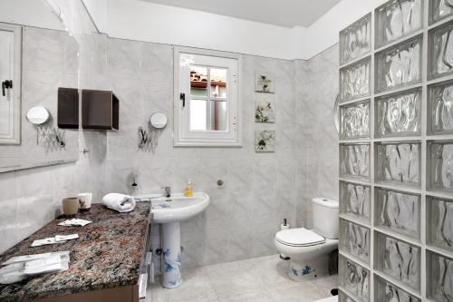 a white bathroom with a sink and a toilet at Eveas - Villa with Pool in Tenerife in Candelaria