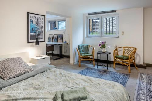 a bedroom with a bed and two chairs and a desk at Gemütliche Unterkunft mit Terrasse in Quickborn