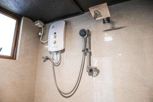 a shower in a bathroom with a shower head at Villa R in Negombo