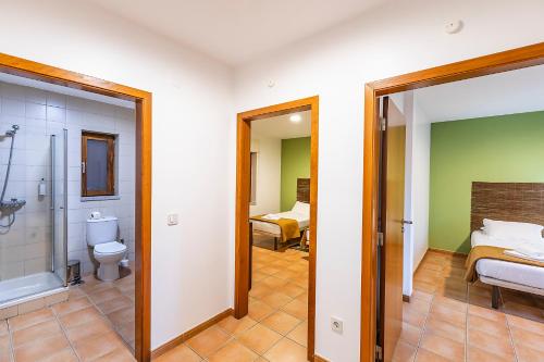 a bathroom with a shower and a toilet and a sink at HI Geres - Pousada de Juventude do Gerês in Geres