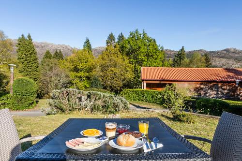 a table with food on top of a blue table at HI Geres - Pousada de Juventude do Gerês in Geres