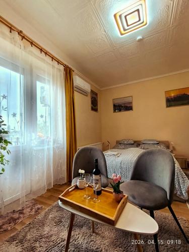 a bedroom with two chairs and a bed and a table at Karancs Apartman Salgótarján in Salgótarján