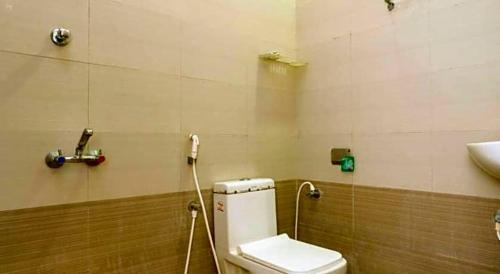 a bathroom with a toilet and a sink at Hotel Ramleela in Rāmeswaram