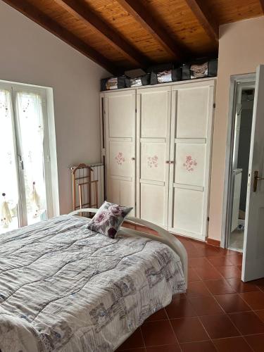 a bedroom with a bed in a room with windows at Maltina country house in Savona