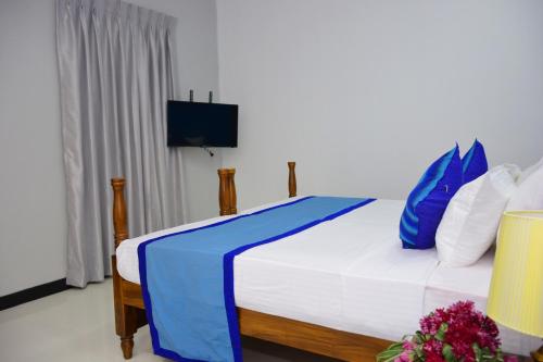 Llit o llits en una habitació de Meili Lanka City Hotel