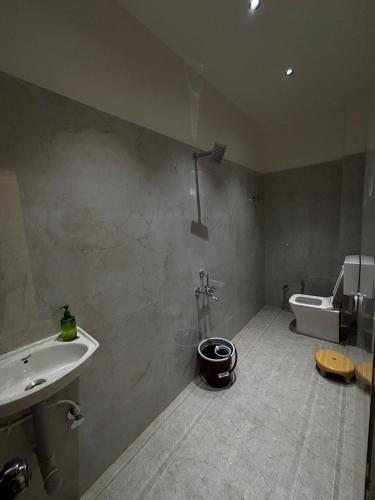 a bathroom with a sink and a tub and a toilet at Hotel Amora in Dighori Buzurg