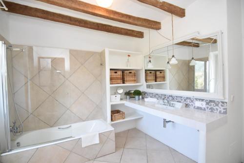 a bathroom with a tub and a sink and a shower at S'abeurada con piscina en Soller in Sóller