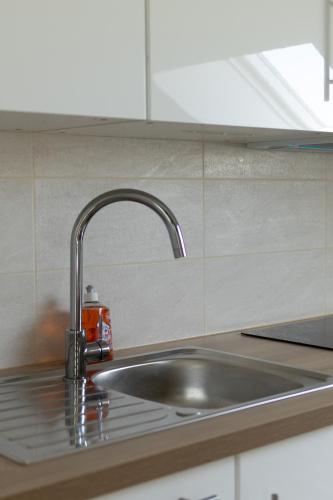 a kitchen sink with a faucet on a counter at Appartement 4 morangis in Morangis