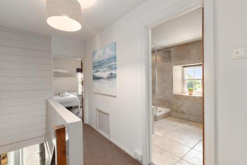 a white bathroom with a sink and a shower at 4 Bed in St. Brides oc-o30488 in Saint Brides