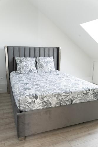 a bed with a metal frame and pillows on it at Appartement 4 morangis in Morangis