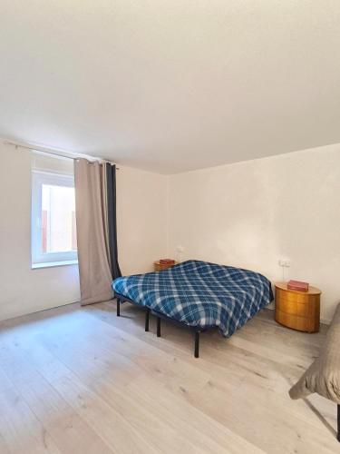 a bedroom with a bed in a room with a window at Levico Antiche Terme Apartment in Levico Terme