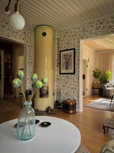a living room with a vase with flowers on a table at House on the hill in Södra Persby