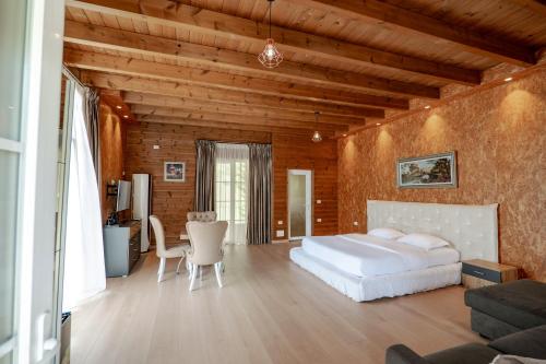 a bedroom with a white bed and a table at Bianca Hotel & Villa Tirana in Tirana