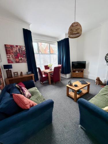 a living room with a couch and a table at Alfie's Den, Bridlington in Bridlington