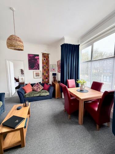 a living room with a couch and a table at Alfie's Den, Bridlington in Bridlington