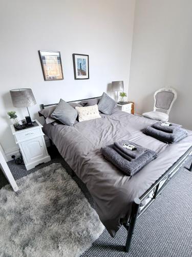 a bedroom with a large bed and a chair at Alfie's Den, Bridlington in Bridlington