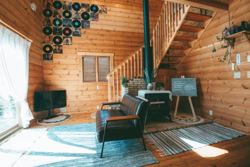 a log cabin with a chair and a television at July In Furano in Nakafurano